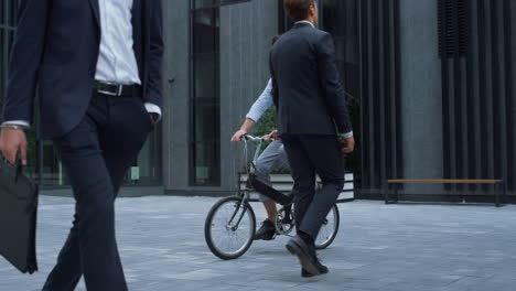 office manager riding bicycle commuting to work. alternative transportation.