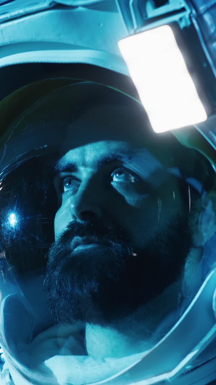 Vertical video Astronaut returning from planet surface takes helmet off, talking with colleague