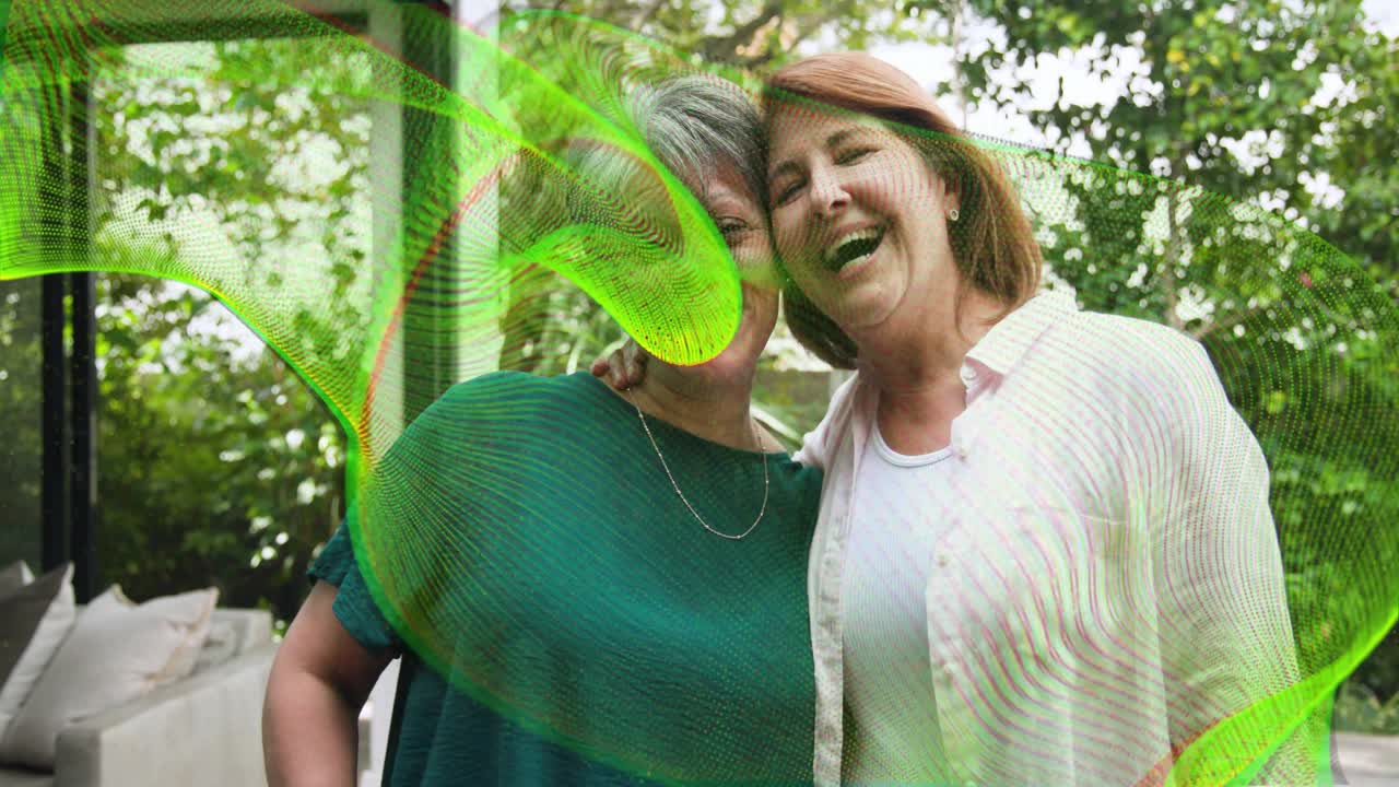 Mature woman placing hand on senior, talk sparking hugging smiling, green wave sweeping lens care