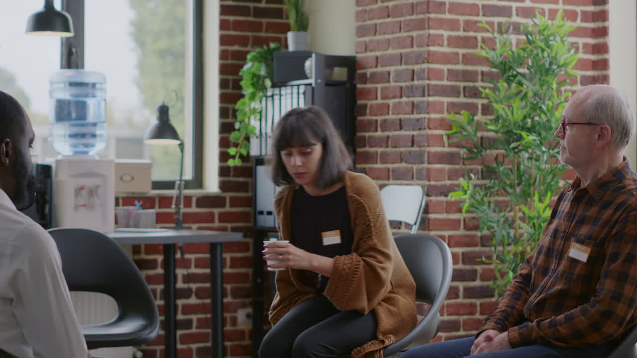 Woman therapist greeting people with addiction at aa rehab session in circle