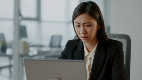 woman suffering from headache and stress while working in the office