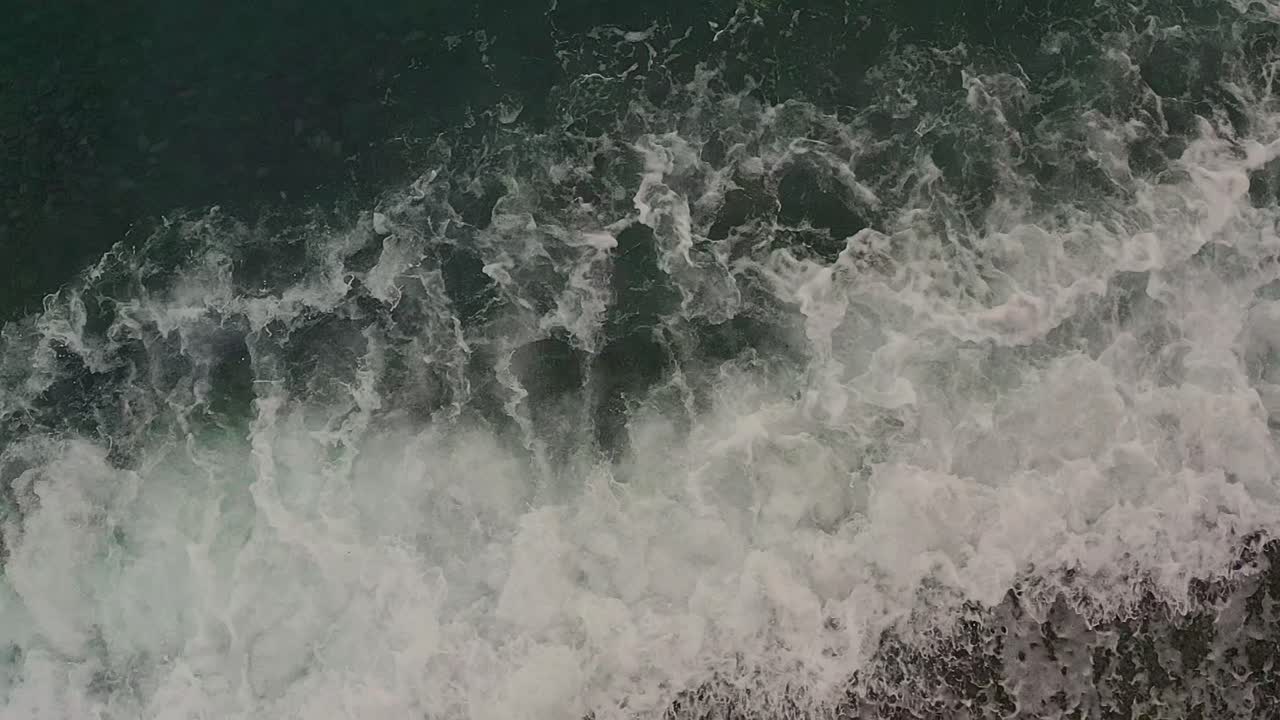 Aerial Drone Top View of Turquoise Ocean Waves Crashing Over the Sandy Shores of the Philippines