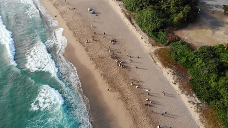 a drone shot of surfers on the beach in kenting