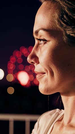 serene woman contemplating vibrant fireworks reflections, capturing emotional moments through dynamic color grading and atmospheric perspectives during nighttime celebration