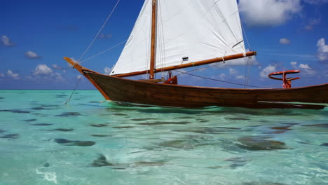 wooden sailboat in turquoise water
