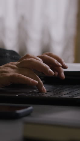 person typing on a laptop