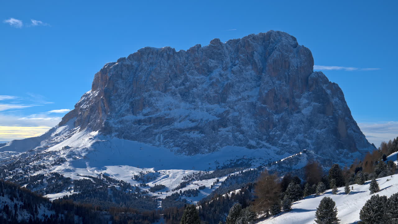 Distant view of snow on the trees and mountains in the Dolomites, Italy