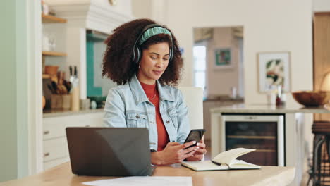 woman working from home on laptop with headphones