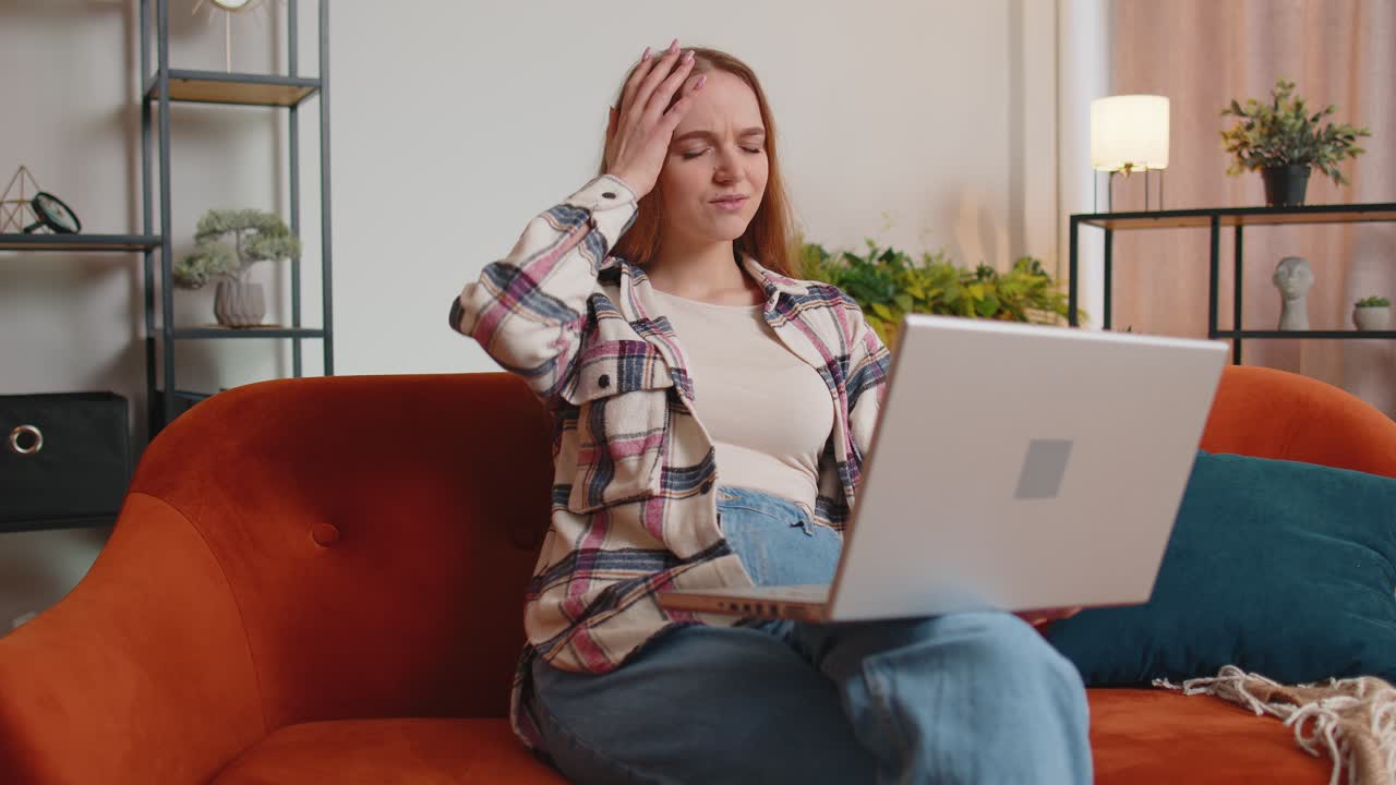 Sad young woman use laptop computer pc browsing loses becoming surprised sudden bad lottery results