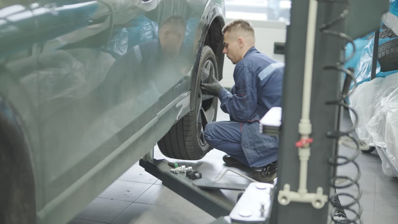 Car Mechanic Working on Vehicle