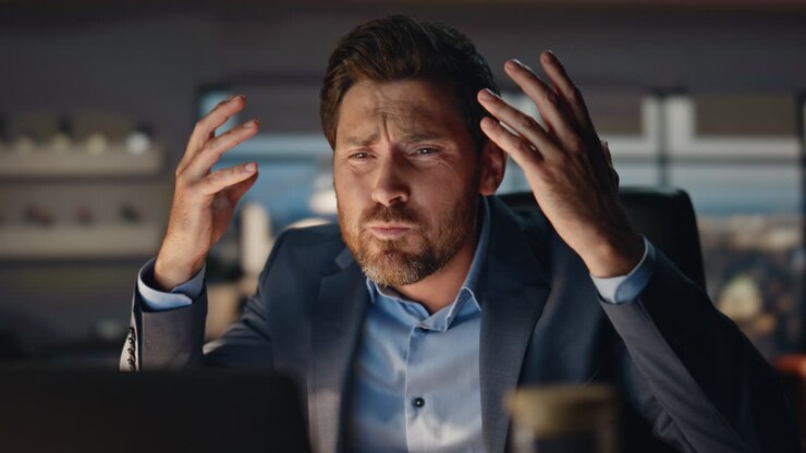 Closeup mad man gesturing hands at evening city view office. Business failure