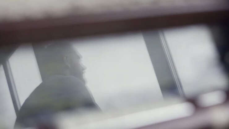 Reflection of a person in a ship's control room