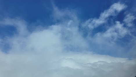 an aerial pilot pov from a jet cockpit breaking through storm clouds into a deep blue clear sky ultra-realistic 4k scene.