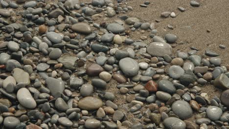 pebbles in sand with wave 15 seconds