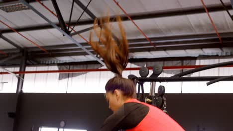 determined beautiful caucasian woman doing jump squat in fitness studio 4k