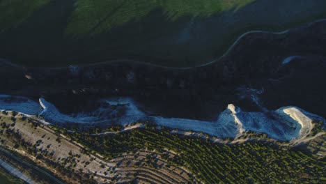 aerial view of a valley with cliffs and farmland