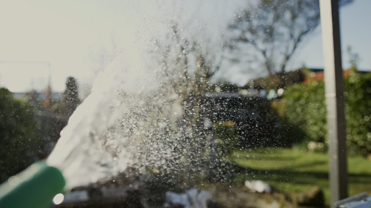 A stream of water sprays out from a garden hose, captured in super slow motion in Middelburg, Netherlands.