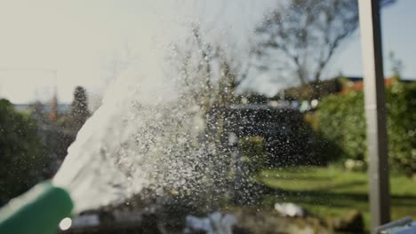 a stream of water sprays out from a garden hose, captured in super slow motion in middelburg, netherlands.