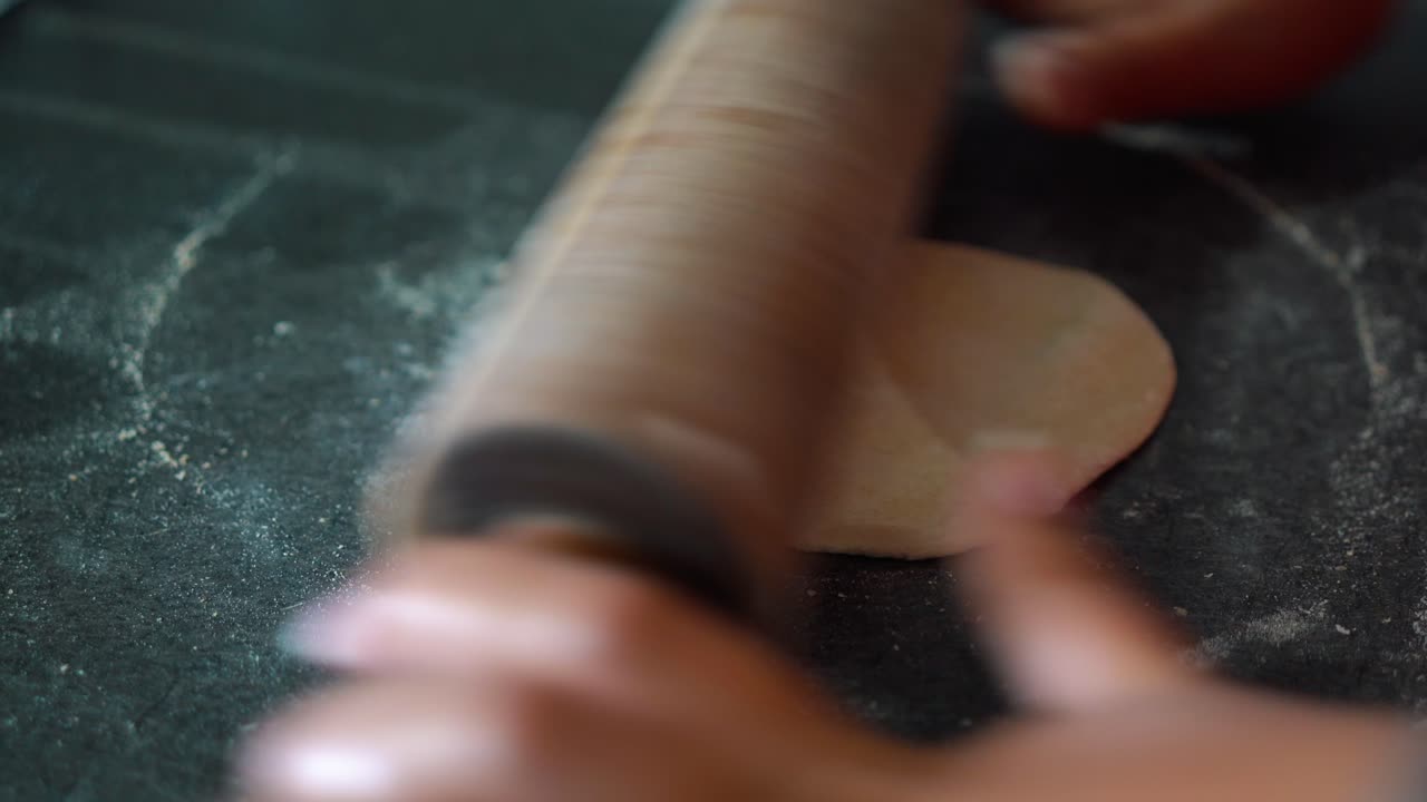 Women rolling dough to make bread