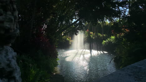 Slomotion-Reveal-of-shaded-water-fountain-on-a-sunny-day