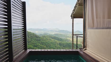 luxury glamping tent with infinity pool beside it overlooking the mountains