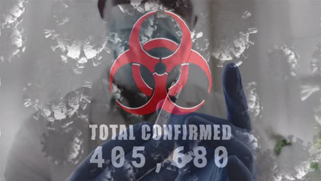 Animation-of-biohazard-symbol-total-confirmed-numbers-and-covid-cells-over-doctor-with-syringe