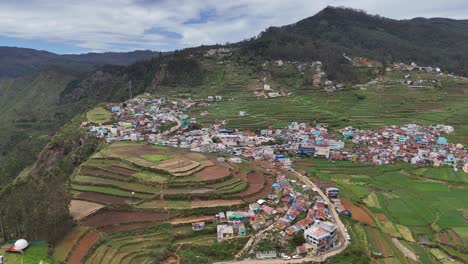 drone flyover showcasing a peaceful blend of man-made homes and natural terrain
