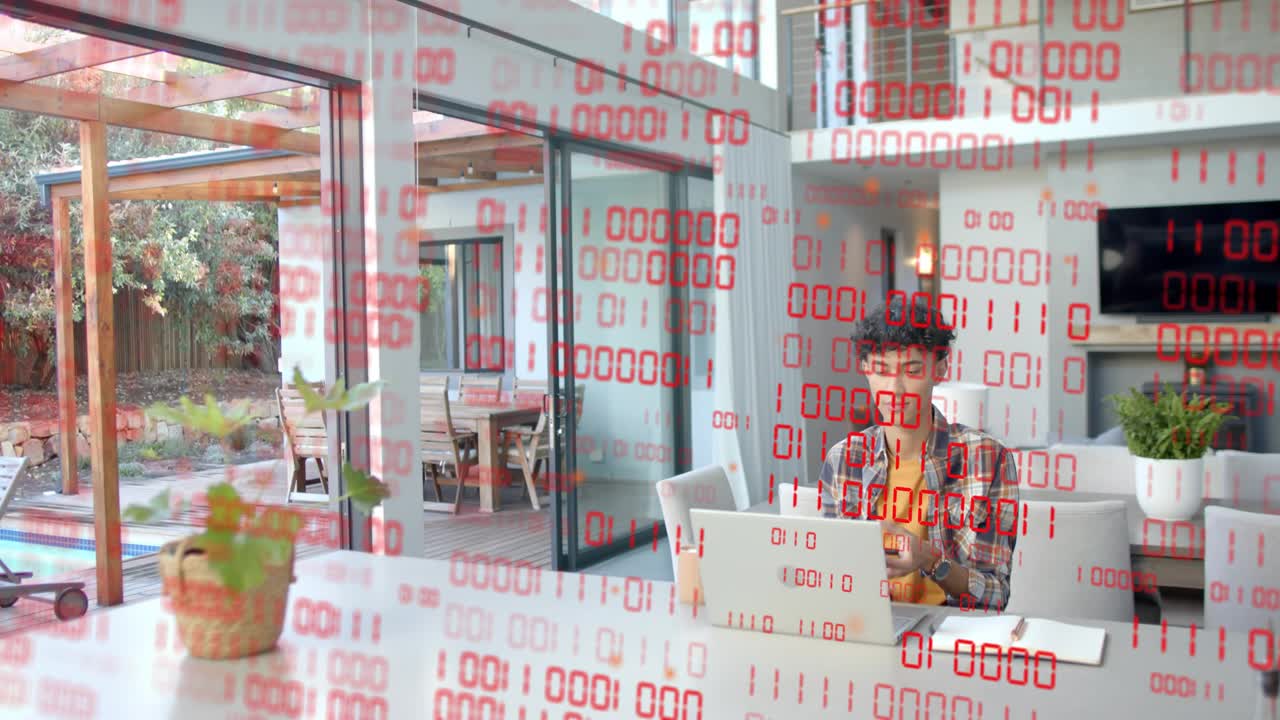 Red binary veil thinning revealing man at table, typing on laptop, tapping phone, working in tech