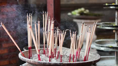 incense sticks burning in a pot