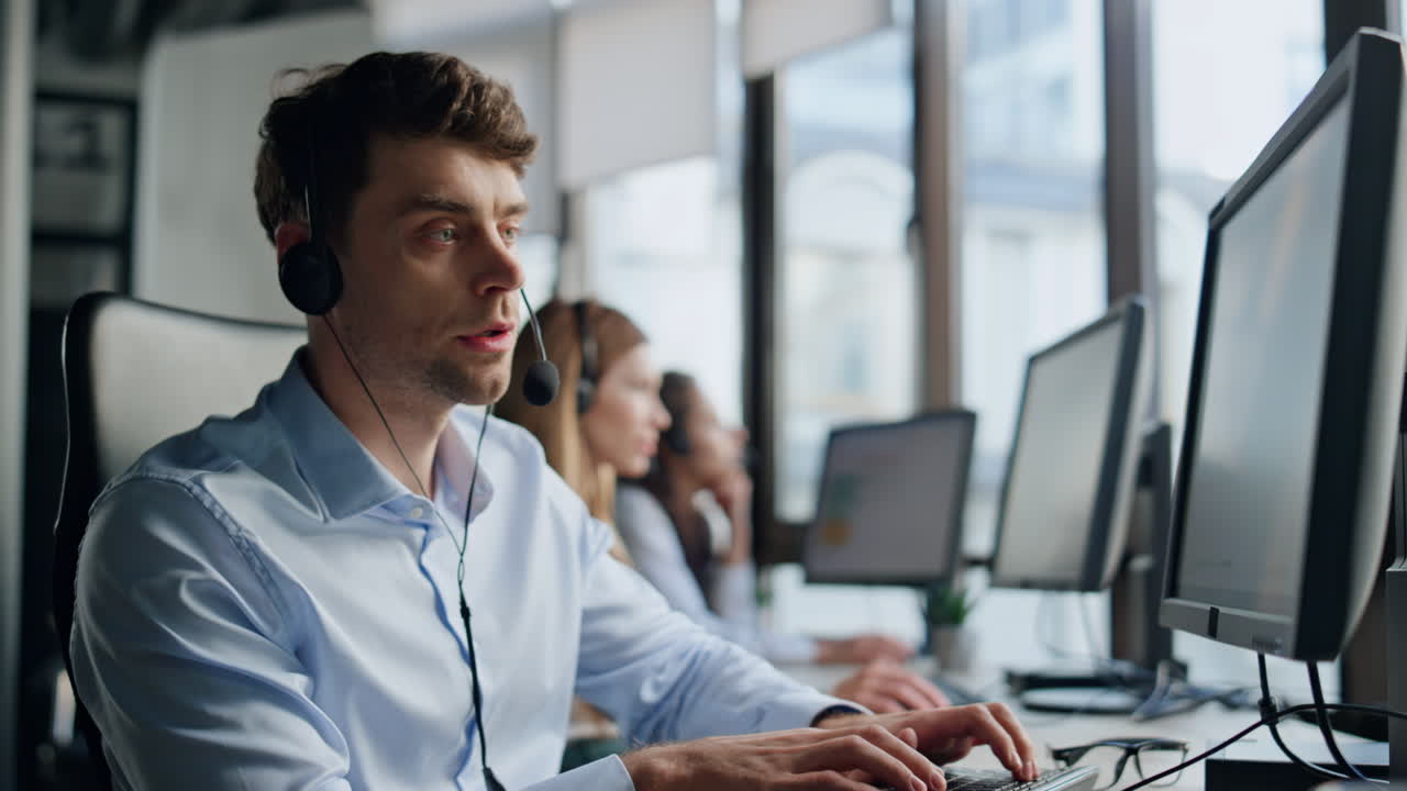 Technical support talk client in office. Pensive man specialist typing computer