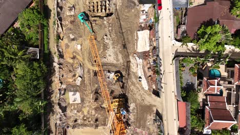 aerial view of a large construction site with cranes and excavators