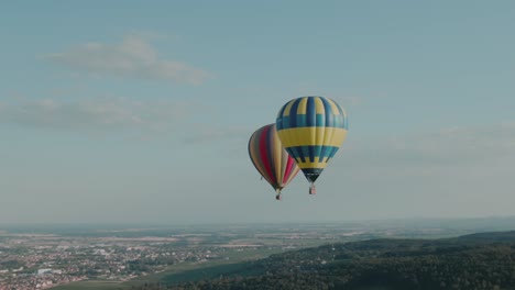 4k aerial two hot air balloons in the sky drone zoom in