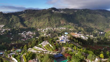 cloud blanket gradually uncovering a vibrant hill town in south india