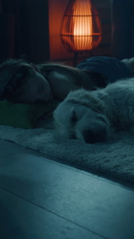 girl and dog sleeping on a cozy floor