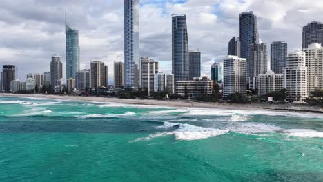aerial hyperlapse showcasing gold coast's skyline with vibrant ocean waves and dynamic cloud movement