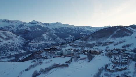 Drone-aerial-view-of-Telluride,-Colorado-with-moody-sunset-in-the-winter