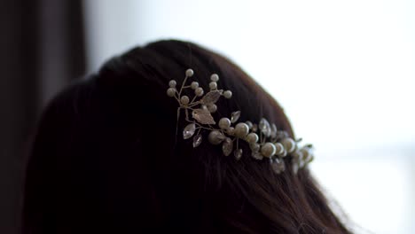 a beautifully captured close-up image showcasing an elegantly dressed bride wearing a headband