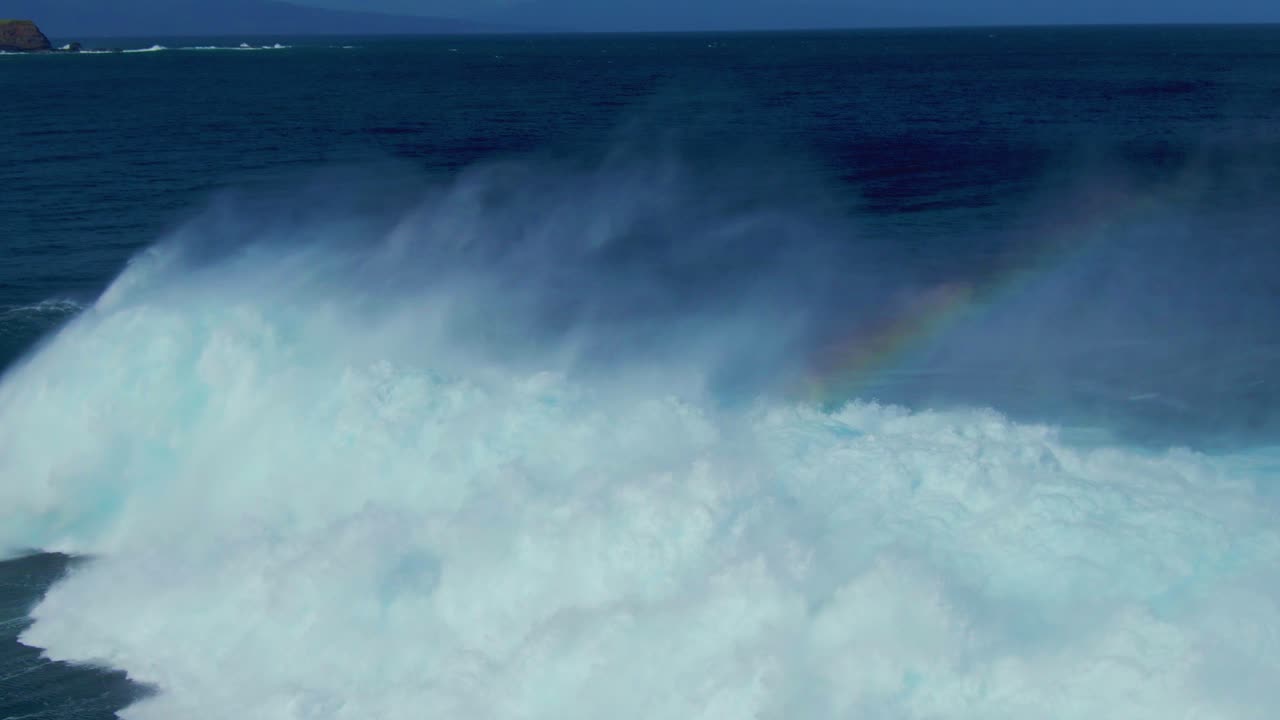 Surfers catching big wave rolling and foaming over blue ocean surface on a surf race competition in Hawaii