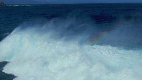 surfers catching big wave rolling and foaming over blue ocean surface on a surf race competition in hawaii
