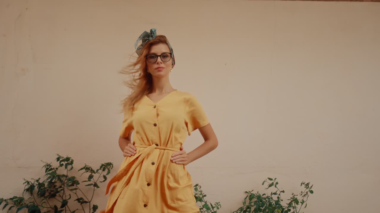 Stylish Woman in Yellow Dress with Glasses Posing