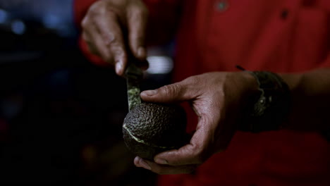 man cutting avocados