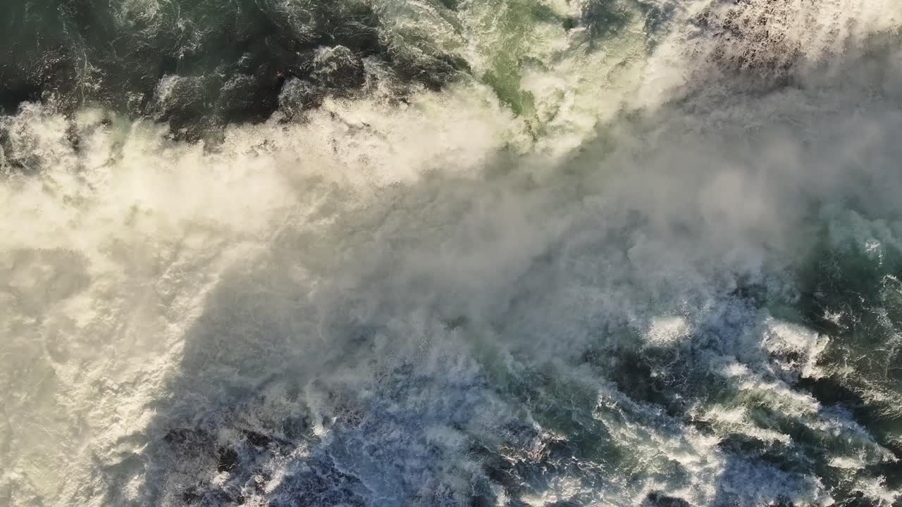 Aerial - raging Urriðafoss waterfall crashing in Iceland's icy winter torrent