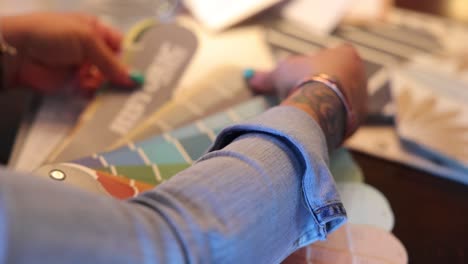 interior designer looks over color swatches for a kitchen remodel