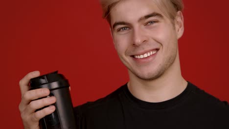 young man holding a protein shake