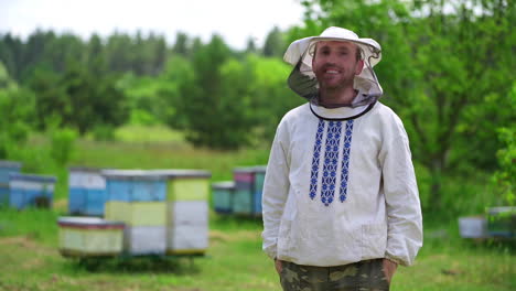 male beekeeper in protective clothing. portrait of beekeeper in protective mask