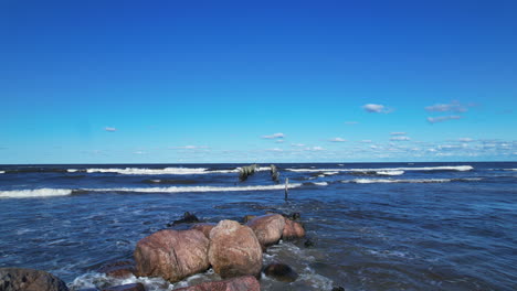 a person standing on rocks near the ocean