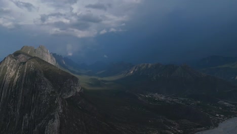 beautiful mountain valley with clouds lightly loaded with water wanting to rain a little with green meadows 4k 60 fps
