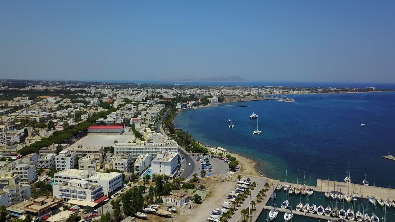 Drone landing shot of the Rhodes island with harbour, city view and a shoreline.