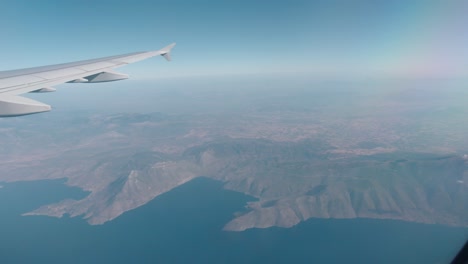 view of the wing of a plane from inside whilst flying