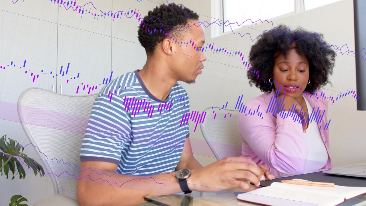 Man moving to chair, woman pointing at laptop, typing making purple charts, reviewing business data